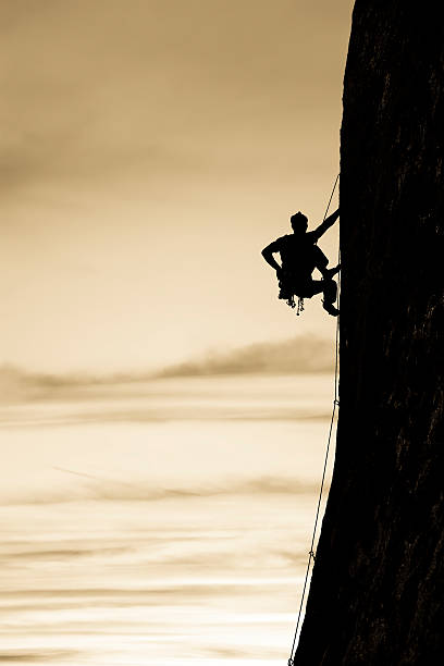 istock Rock climber clinging to a cliff. 156199271