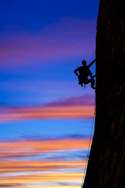 istock Rock climber clinging to a cliff. 156199273