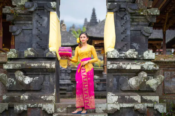 Indonesian girl with traditional costumn dance in bali temple, indonesia