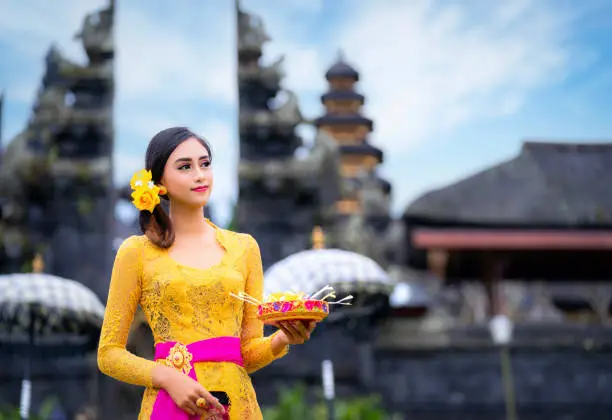 Indonesian girl with traditional costumn dance in bali temple, indonesia