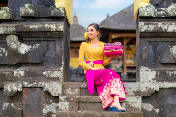 Indonesian girl with traditional costumn dance in bali temple, indonesia