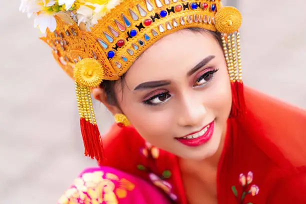 Indonesian girl with traditional costumn dance in bali temple, indonesia