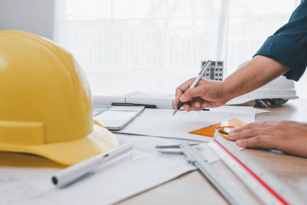 istock engineer working in office with blueprints, inspection in workplace for architectural plan, construction project ,Business construction 1562002880