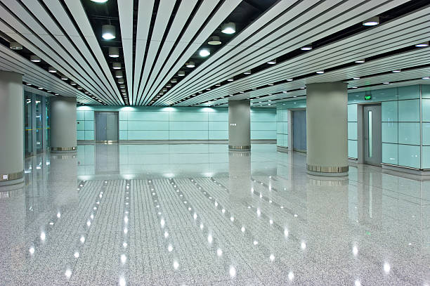 istock Vast and empty hallway with many overhead lights 156200361