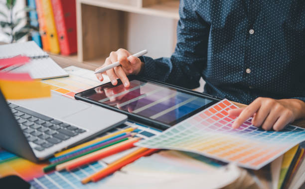 istock Graphic designer architects who work with laptops and color comparison tables for design work. 1562003995