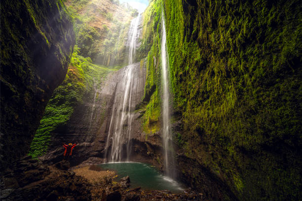 istock Asian traveller Man in Madakaripura Waterfall 1562005099