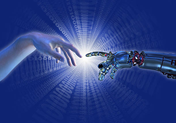 A human hand touching a hand of a robot stock photo