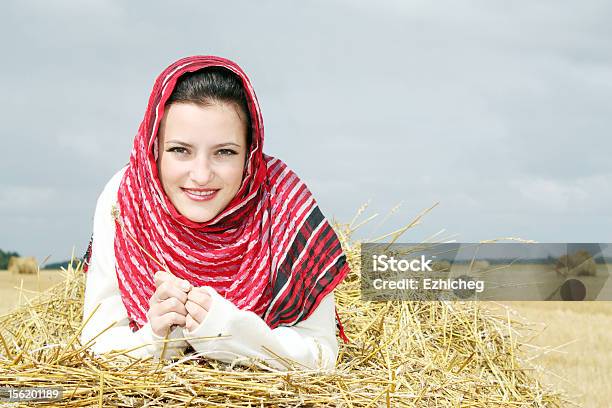 Smiling Girl On A Stack Of Straw Stock Photo - Download Image Now - 20-29 Years, Adult, Adults Only