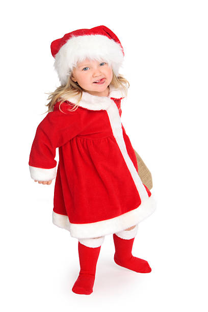 Little Girl in Santa suit, carrying a bag of christmas presents and sticking out her tongue