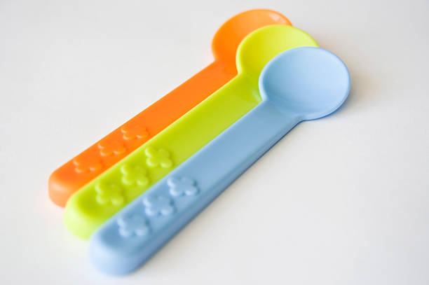Three baby spoons 3 coloured baby spoons baby spoon stock pictures, royalty-free photos & images