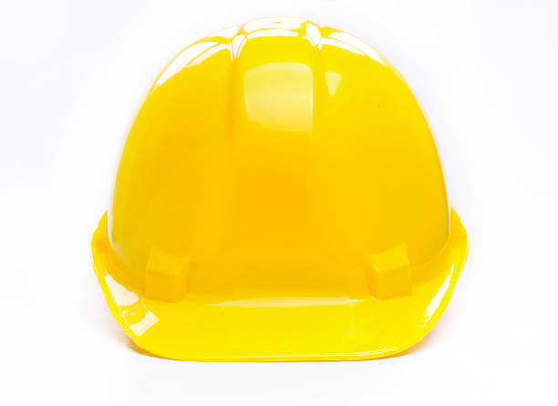 A bright yellow shiny hard hat stock photo