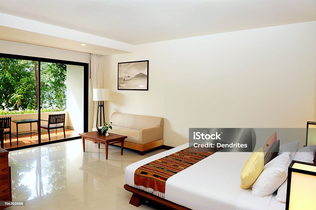 Luxury hotel room Modern hotel bedroom with terrace. View on garden from terrace window. Green Color Stock Photo