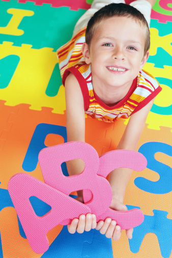 7 years old boy with colorful letters - kids