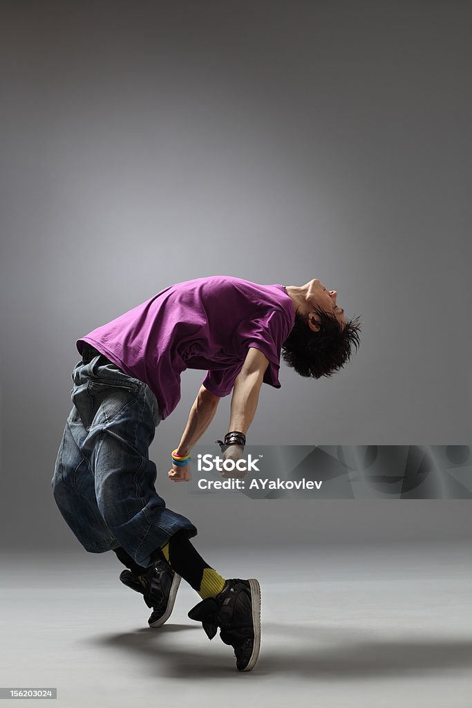 the dancer modern dancer poses in front of the gray background Acrobat Stock Photo