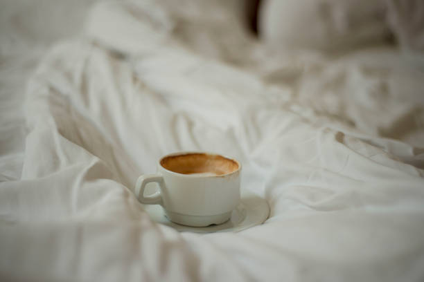 istock a cup of coffee on a rumpled bed, morning coffee in bed 1562040526