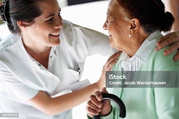 Happy Young Nurse With An Old Patient Stock Photo - Download Image Now - 20-24 Years, 20-29 Years, 60-64 Years
