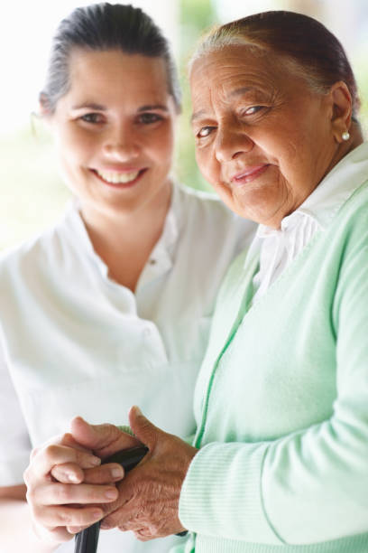istock Elderly woman smiling with a nurse 156205115