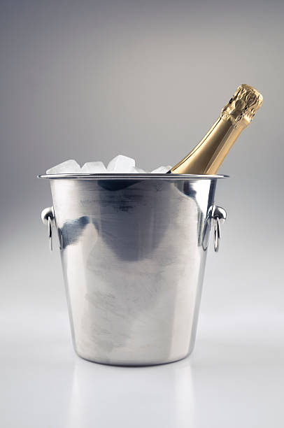 Champagne bottle in ice bucket stock photo