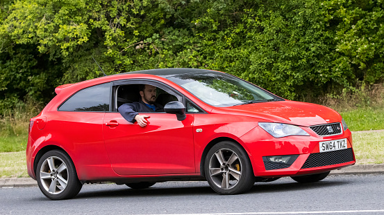 Milton Keynes,UK - July 21st 2023: 2015 red Seat Ibiza  car driving on an English road