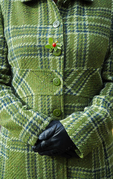 women's trunk in green coat and black gloves stock photo