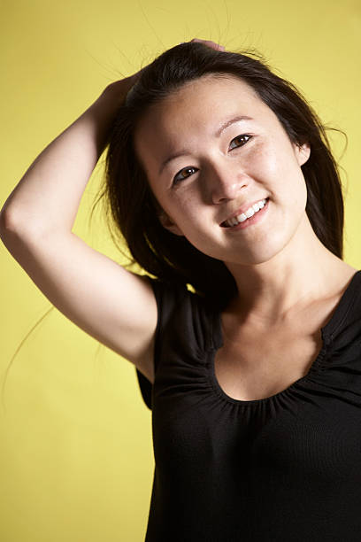 Young woman fixing her hair stock photo