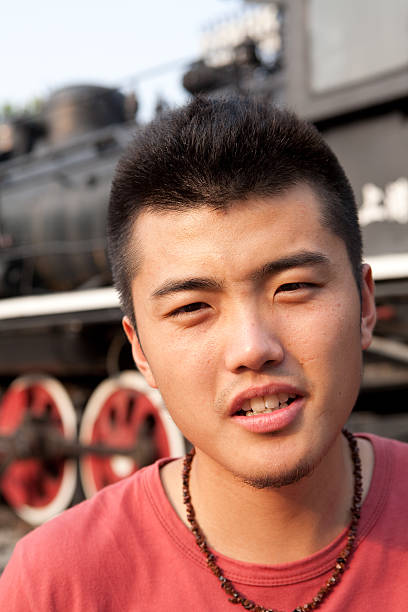 istock Young asian student stand in front of old train 156207610