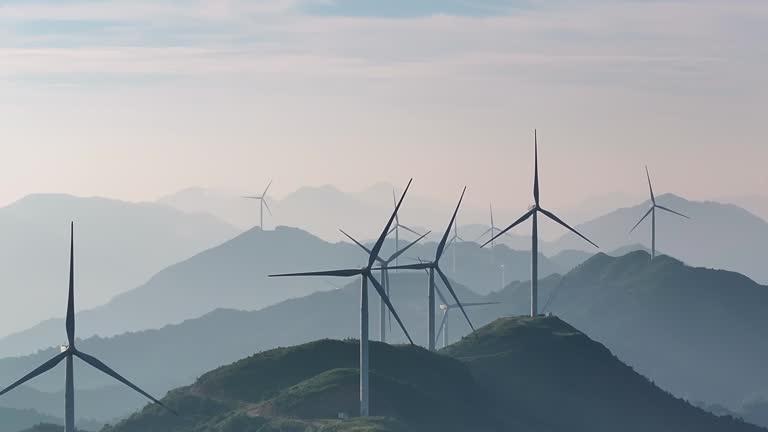 A rotating wind turbine at the top of a mountain