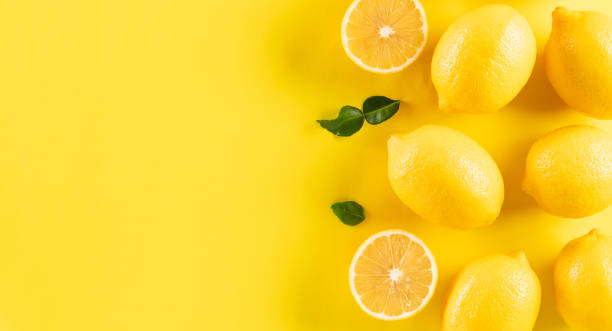 istock Summer composition made from oranges and lemon  on pastel yellow background. Fruit minimal concept. 1562103802