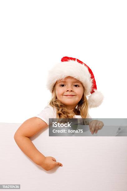 少女のクリスマス帽子を指す白いバナー - カジュアルウェアのストックフォトや画像を多数ご用意 - カジュアルウェア, クリスマス, サンタの帽子