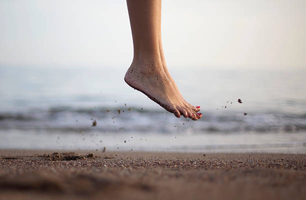 Jumping Foot shot on the beach in the air