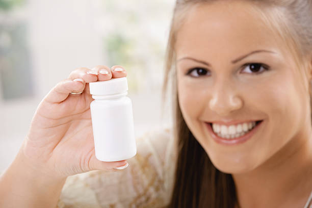 istock Woman showing pill bottle 156211855