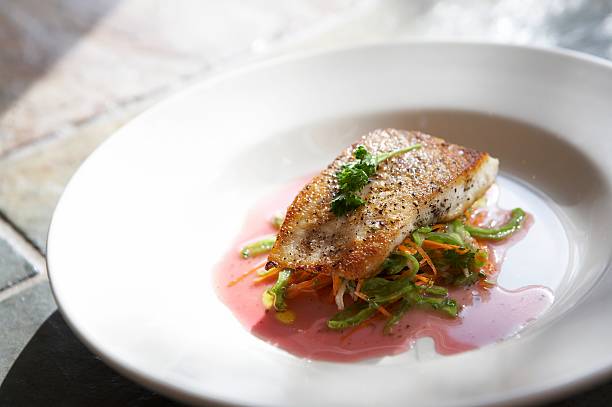 istock Grilled fish with garnish over vegetables 156212257