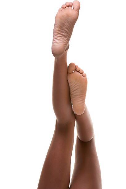 slender legs and feet of African-American woman stock photo