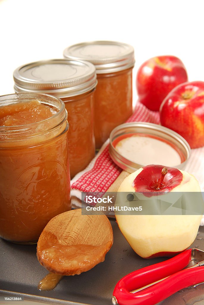 Preserving freshly made applesauce Kitchen scene showing the preserving of freshly made applesauce Apple Sauce Stock Photo