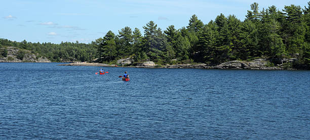 istock Two red canoes on a pretty lake 156214671