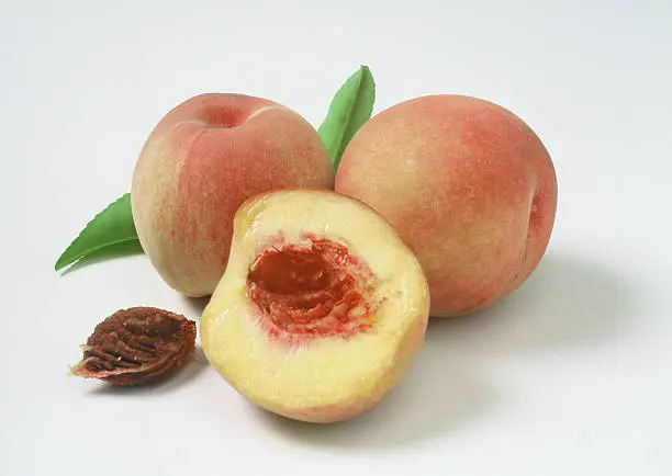 group of peaches with cut-up half