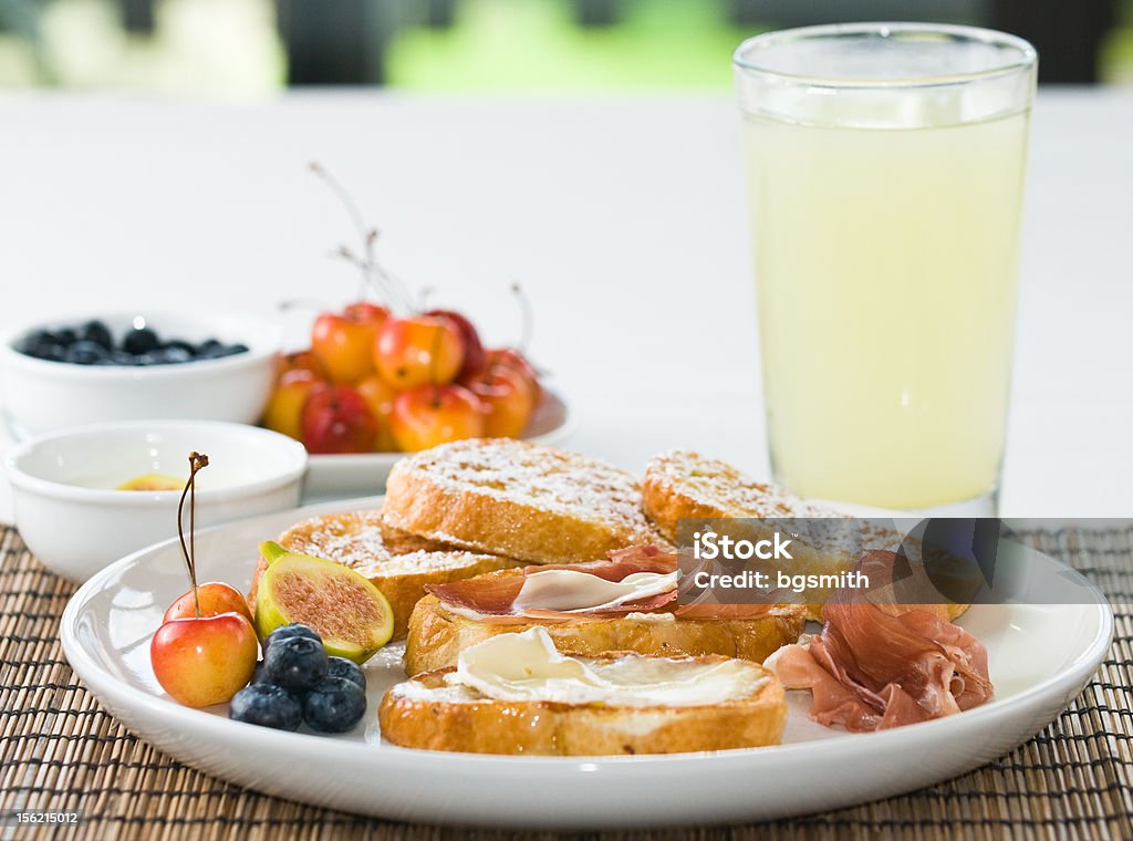 Gourmet French Toast Gourmet breakfast of French Toast with prosciutto and brie, with fresh fruit and yogurt Blueberry Stock Photo