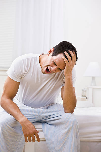 istock Attractive Man Yawning and Looking Sleepy 156215100