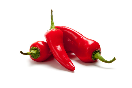A group of hot red peppers or fresno peppers on white background