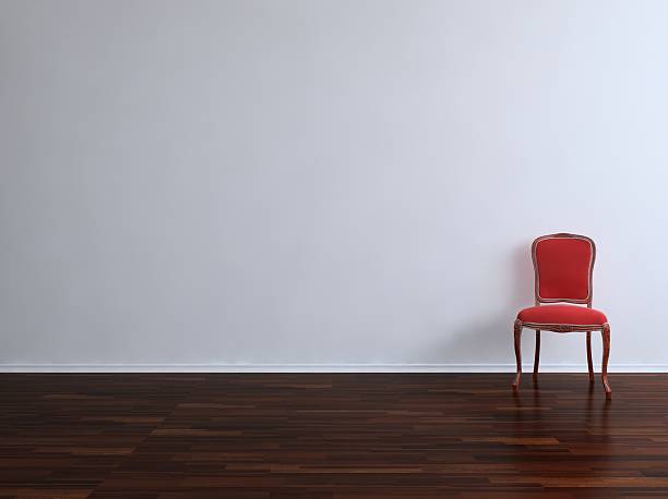 istock A red chair up against a blank wall 156217390