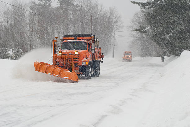 istock Orange snow plow plowing snow on an empty street 156217547