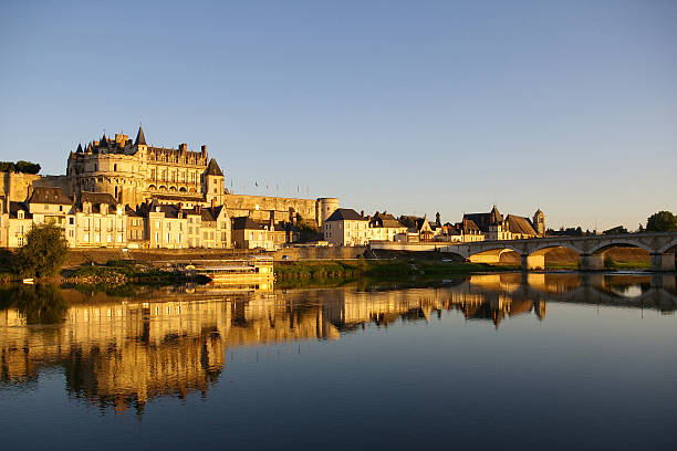 Amboise castle reflected in the water at dusk Beautifull castle in Amboise, France. Picture taken during sunset. loire valley photos stock pictures, royalty-free photos & images