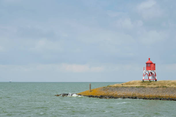 istock Red beacon on a pier at the start of Stavoren harbor 1562233112