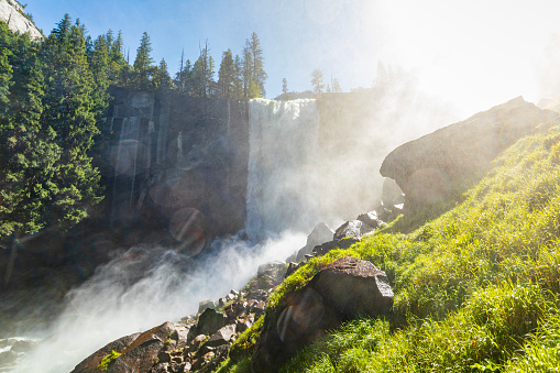 Powerful flowing waterfall in nature. Vernal Falls trail, Yosemite Valley National Park during peak snowmelt 2023, California, USA.