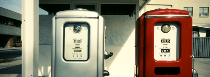 A pair of restored 1960s gas pumps. The photo is shot with a panoramic camera (Hasselbad XPAN) and 45mm lens. Film is Fuji Provia 100F. The image is slightly toned and the contrast is increased.
