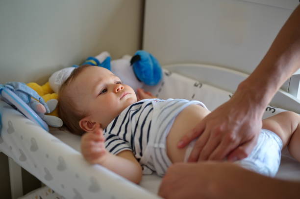 istock Father changing diapers of his son 1562318514