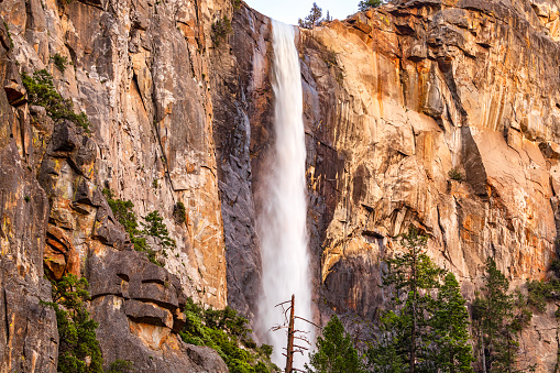 Bridalveil Falls flowing in afternoon light during record season snowmelt in 2023, Yosemite Valley, National Park, California, USA.
