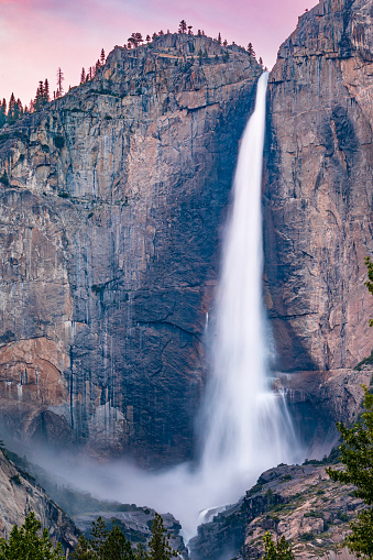 Yosemite Falls peak flow from snowmelt at sunset during record season snowmelt in 2023, Yosemite Valley, National Park, California, USA.