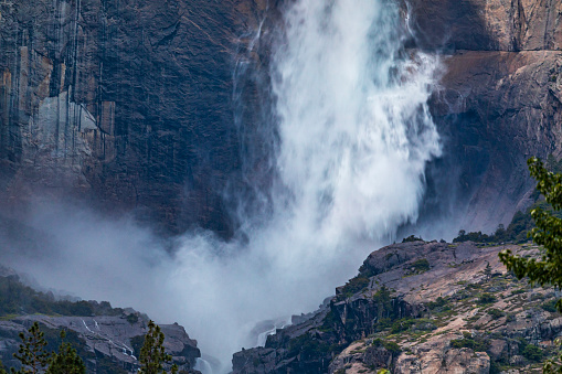 Close up of Yosemite Falls peak flow from snowmelt at sunset during record season snowmelt in 2023, Yosemite Valley, National Park, California, USA.
