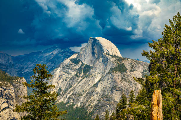 Storm forming over half dome in Yosemite National Park Storm forming over half dome in Yosemite National Park in summer, Yosemite Valley, National Park, California, USA. mariposa county stock pictures, royalty-free photos & images